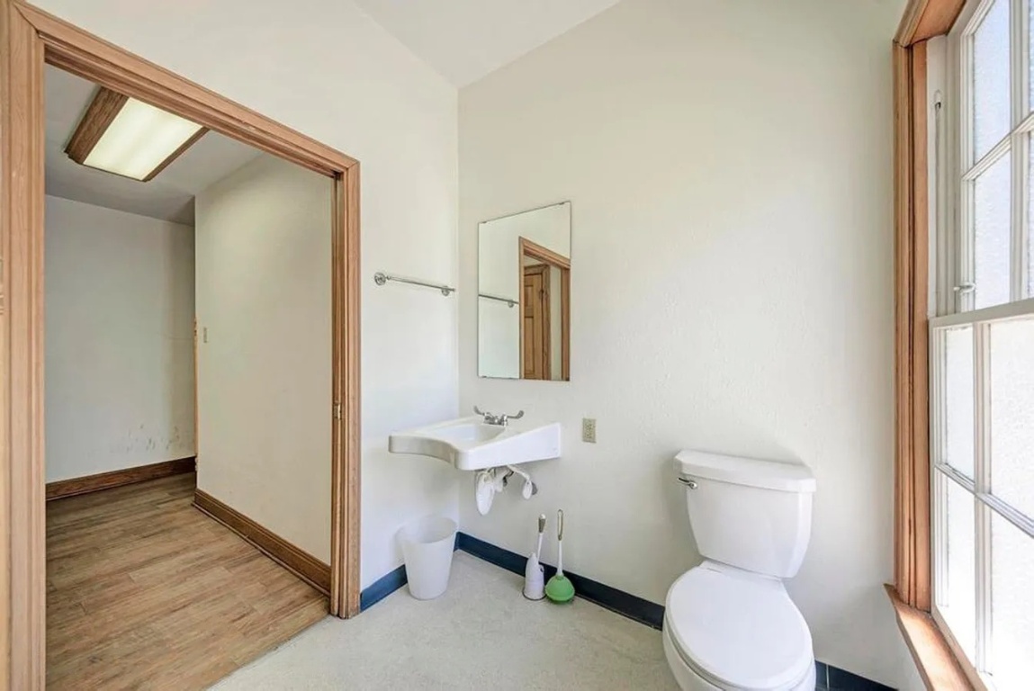 1919 Robbins Place Austin, TX 78705 - Photo 23 of 28 a bathroom with a toilet sink and a mirror