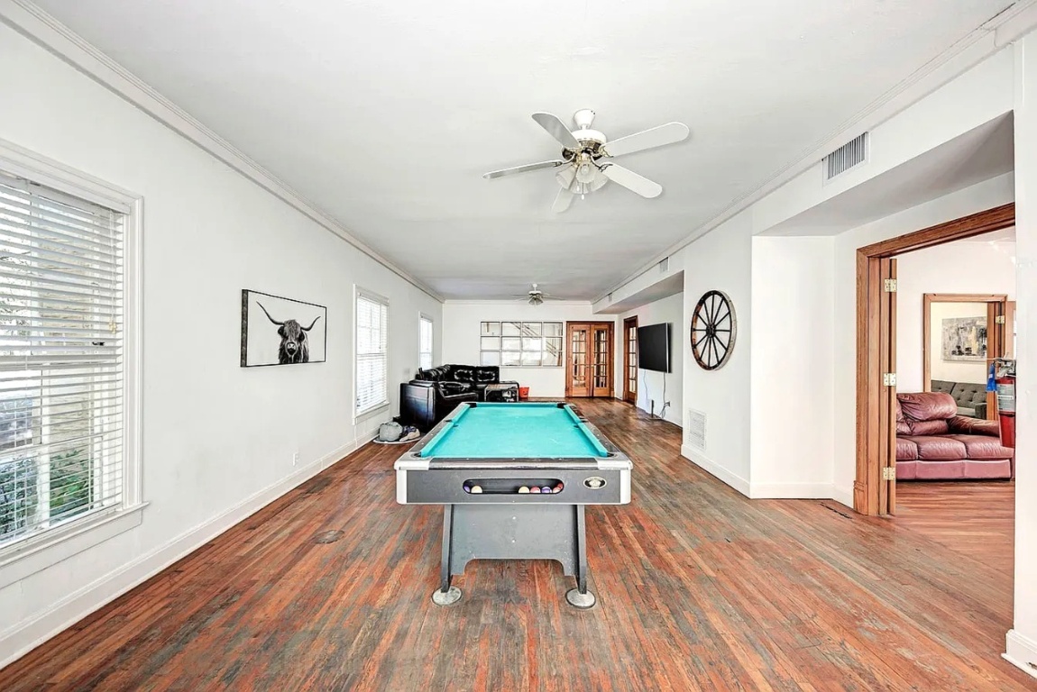 1919 Robbins Place Austin, TX 78705 - Photo 5 of 28 a room with wooden floor pool table and windows