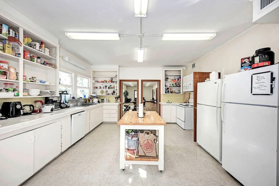 1919 Robbins Place Austin, TX 78705 - Photo 6 of 28 a kitchen with a refrigerator a stove cabinets and a center island