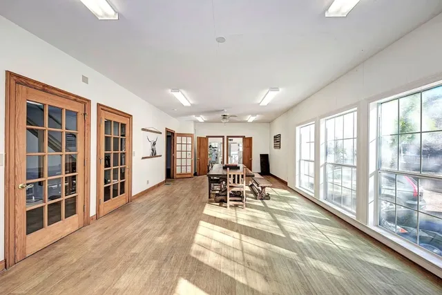 a view of living room with furniture and large windows