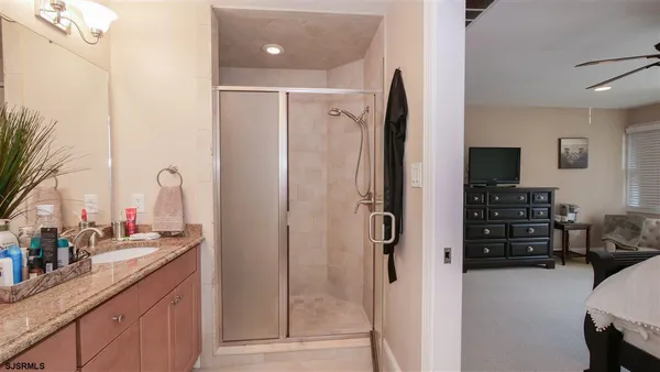 a bathroom with a double vanity sink a mirror and a shower