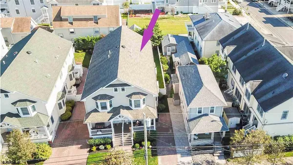 an aerial view of houses with outdoor space