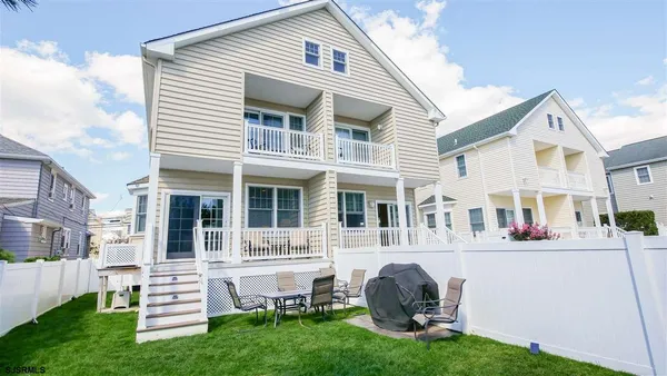a view of a house with a yard and sitting area