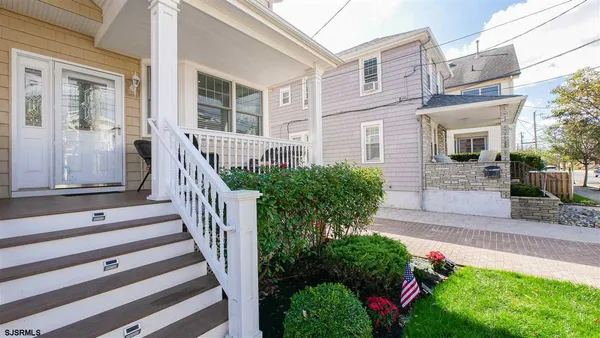 a view of a house with entrance and garden