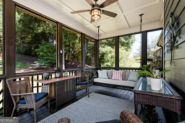 a dining room with furniture a chandelier and wooden floor