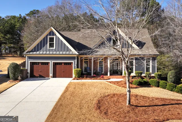 a view of a house with backyard and sitting area