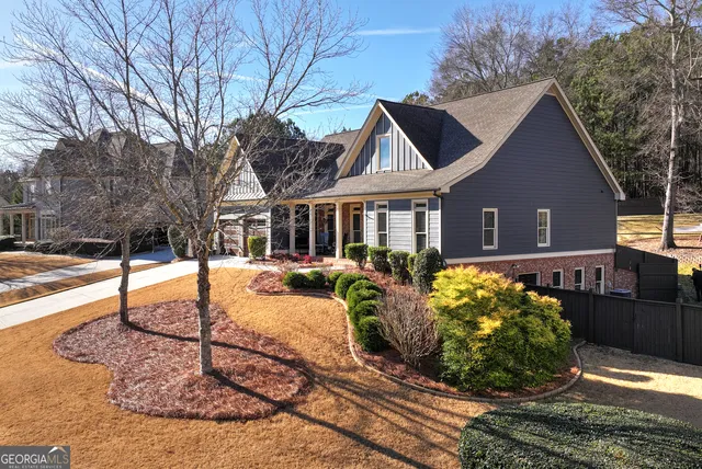 a front view of a house with a yard outdoor seating and garage
