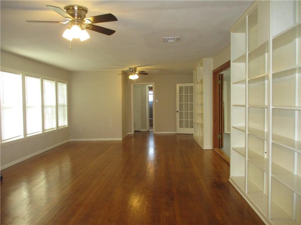 4110 Callicoatte Road Corpus Christi, TX 78410 - Photo 4 of 16 a view of an empty room with window and wooden floor