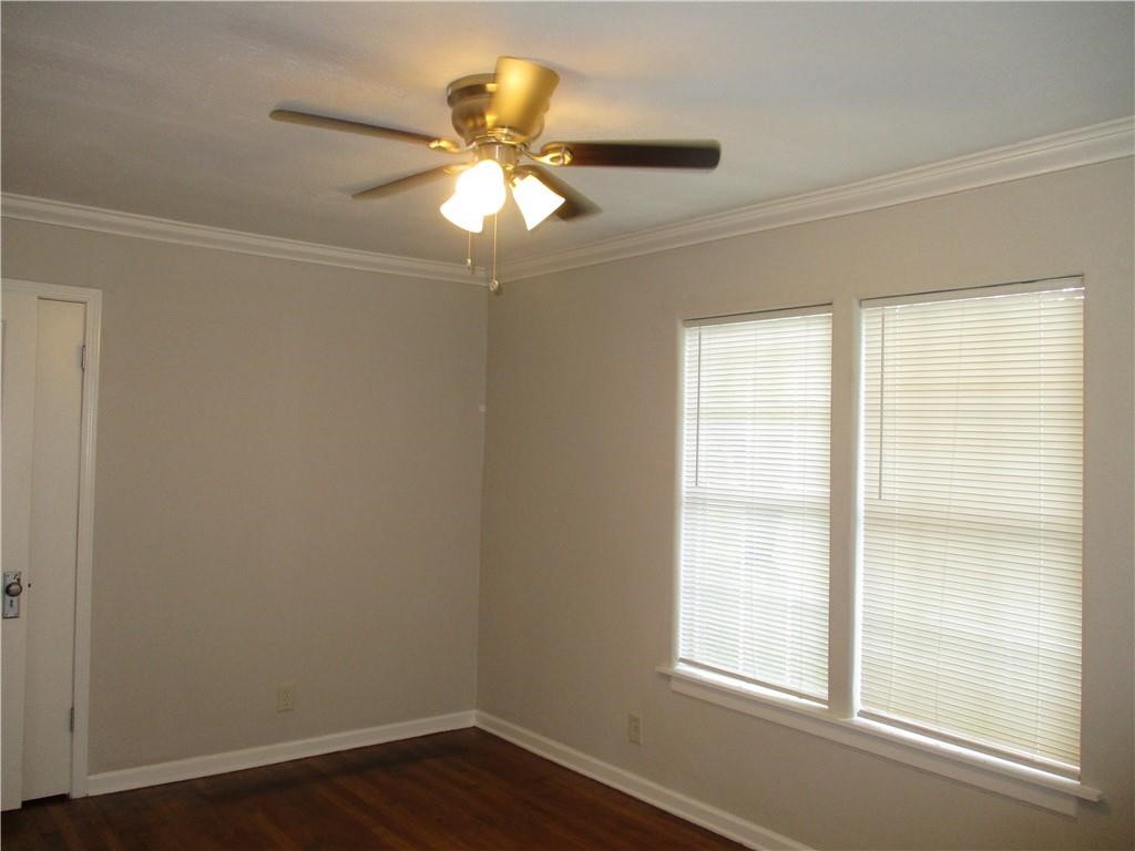 4110 Callicoatte Road Corpus Christi, TX 78410 - Photo 9 of 16 a view of an empty room with wooden floor and a window