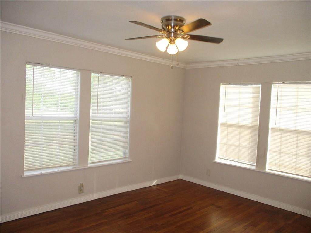 4110 Callicoatte Road Corpus Christi, TX 78410 - Photo 10 of 16 a view of an empty room with a window and wooden floor