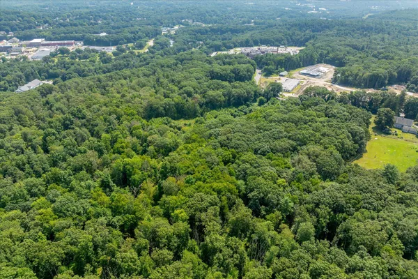 an aerial view of a house with a yard and outdoor seating