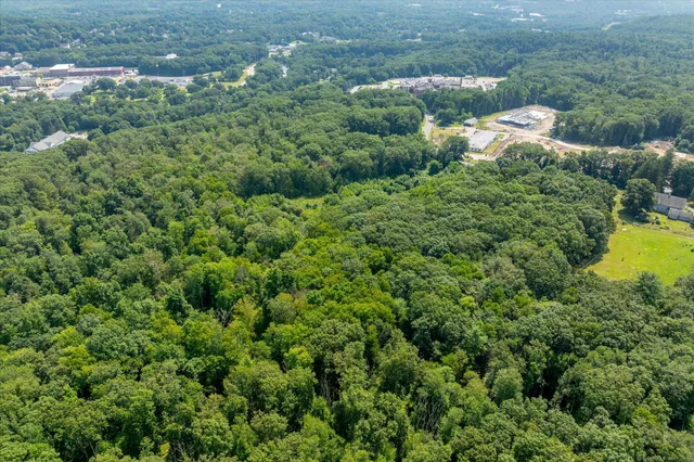 an aerial view of a house with a yard and outdoor seating