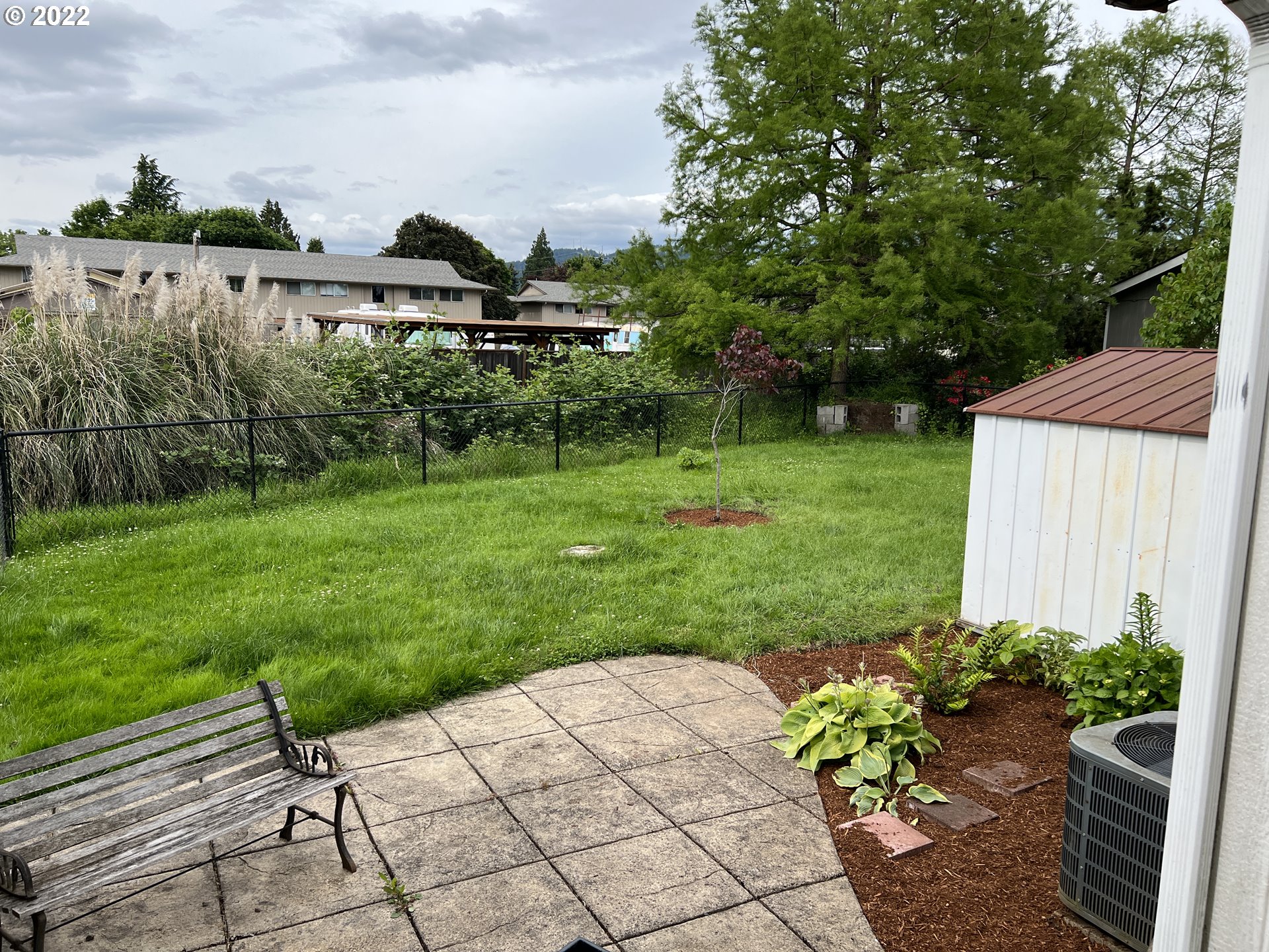 2150 Laura Street, Unit 211 Springfield, OR 97477 - Photo 5 of 14 a view of a back yard of the house and a garden