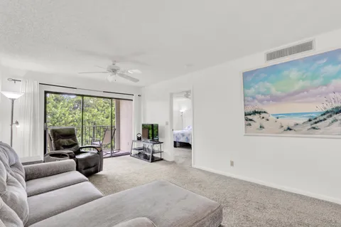 a living room with furniture and large windows