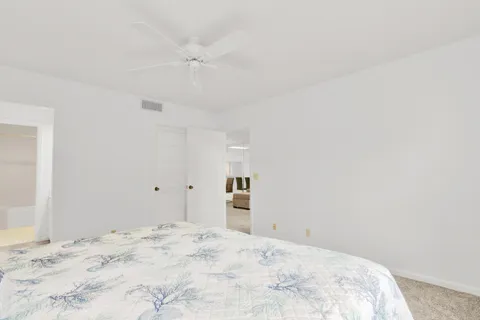 a big room with a bed and a dresser