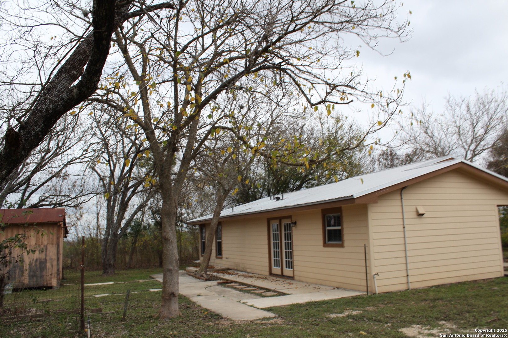 3339 Marion Road Marion, TX 78124 - Photo 18 of 19 a view of a white house with a large tree