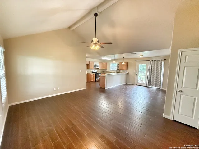 wooden floor in an empty room with a window
