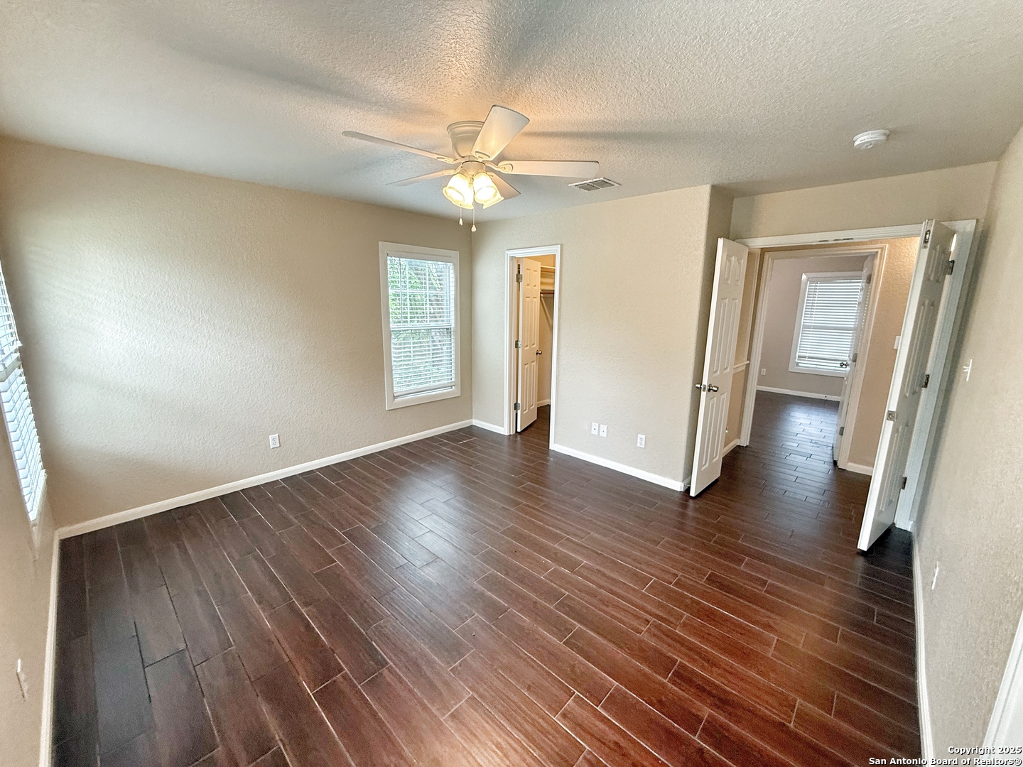 3339 Marion Road Marion, TX 78124 - Photo 9 of 19 an empty room with wooden floor and windows
