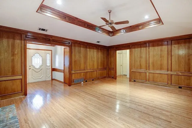 a view of an empty room with a fireplace and a window