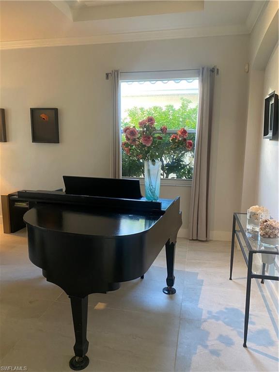 5717 Lago Villaggio Way Naples, FL 34104 - Photo 8 of 11 a living room with furniture and a flat screen tv