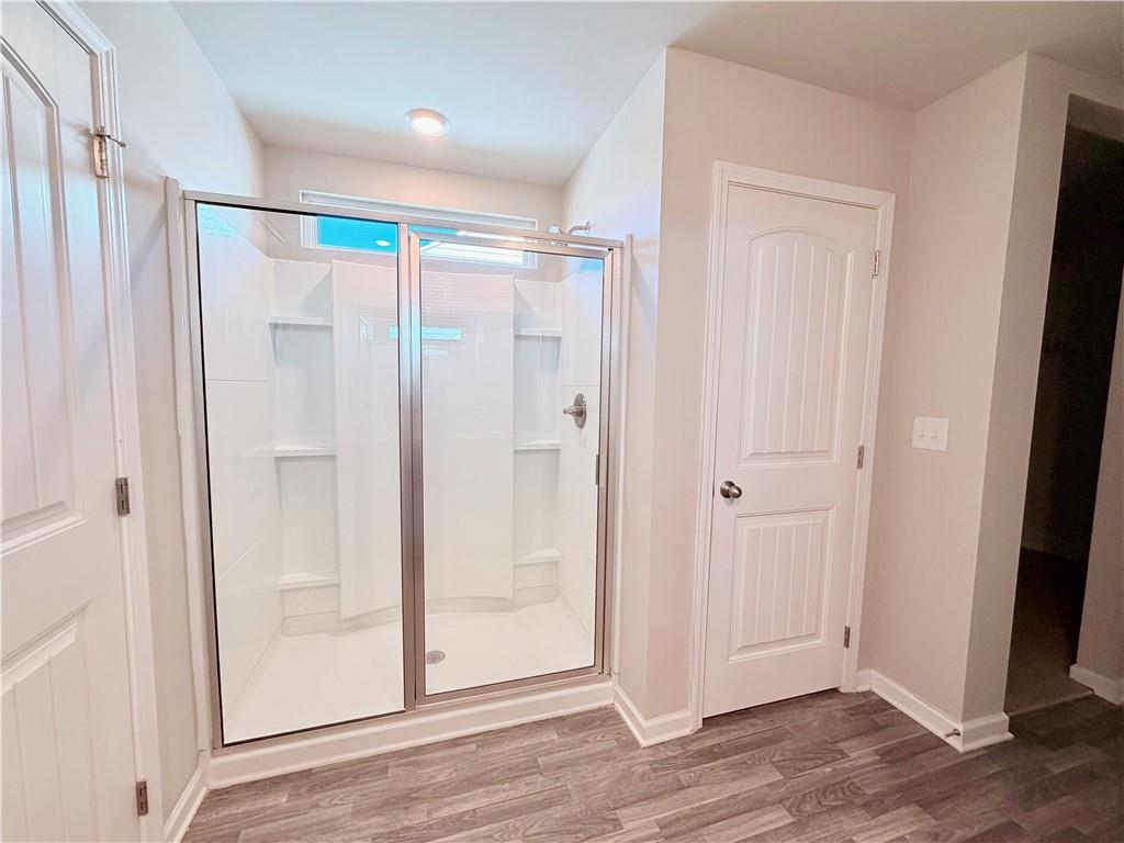 4749 Rdg Vly Drive Gainesville, GA 30504 - Photo 11 of 24 a bathroom with a glass shower door