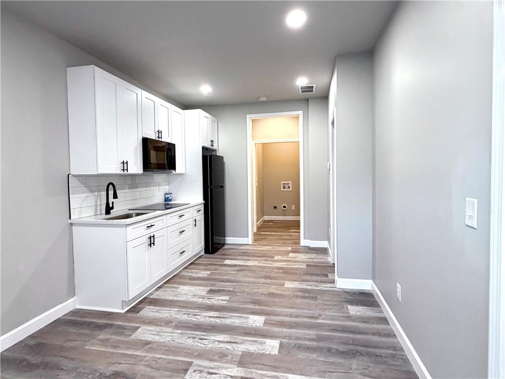 4749 Rdg Vly Drive Gainesville, GA 30504 - Photo 20 of 24 a large white kitchen with stainless steel appliances stove refrigerator and cabinets