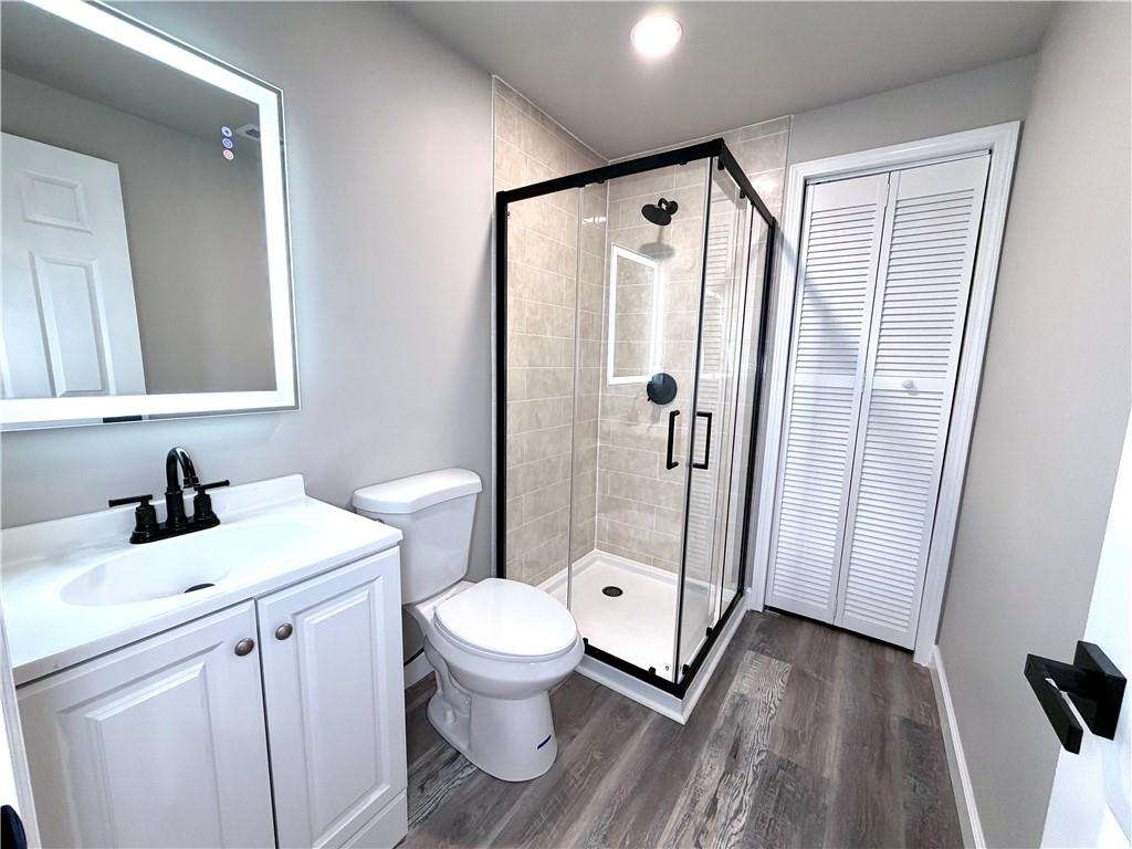 4749 Rdg Vly Drive Gainesville, GA 30504 - Photo 22 of 24 a bathroom with a sink a toilet a mirror and shower