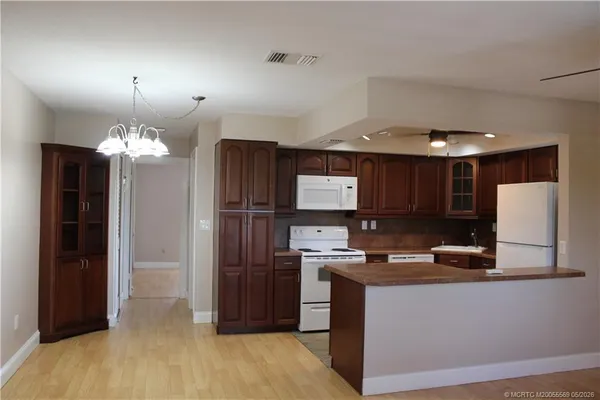 a kitchen with kitchen island granite countertop stainless steel appliances and a counter top space