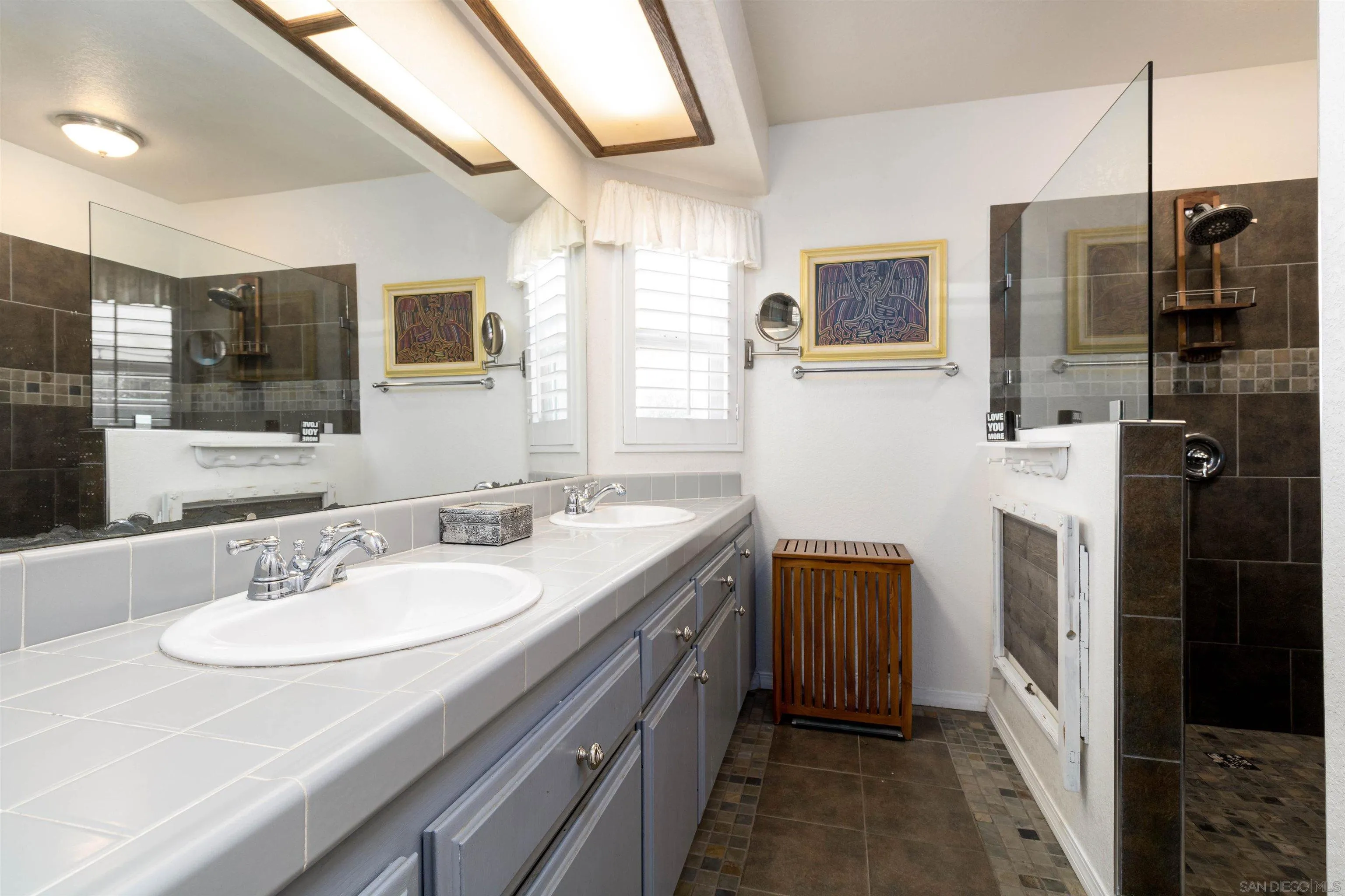 27373 Carlata Lane Valley Center, CA 92082 - Photo 15 of 22 a bathroom with a granite countertop sink a mirror a bathtub and shower