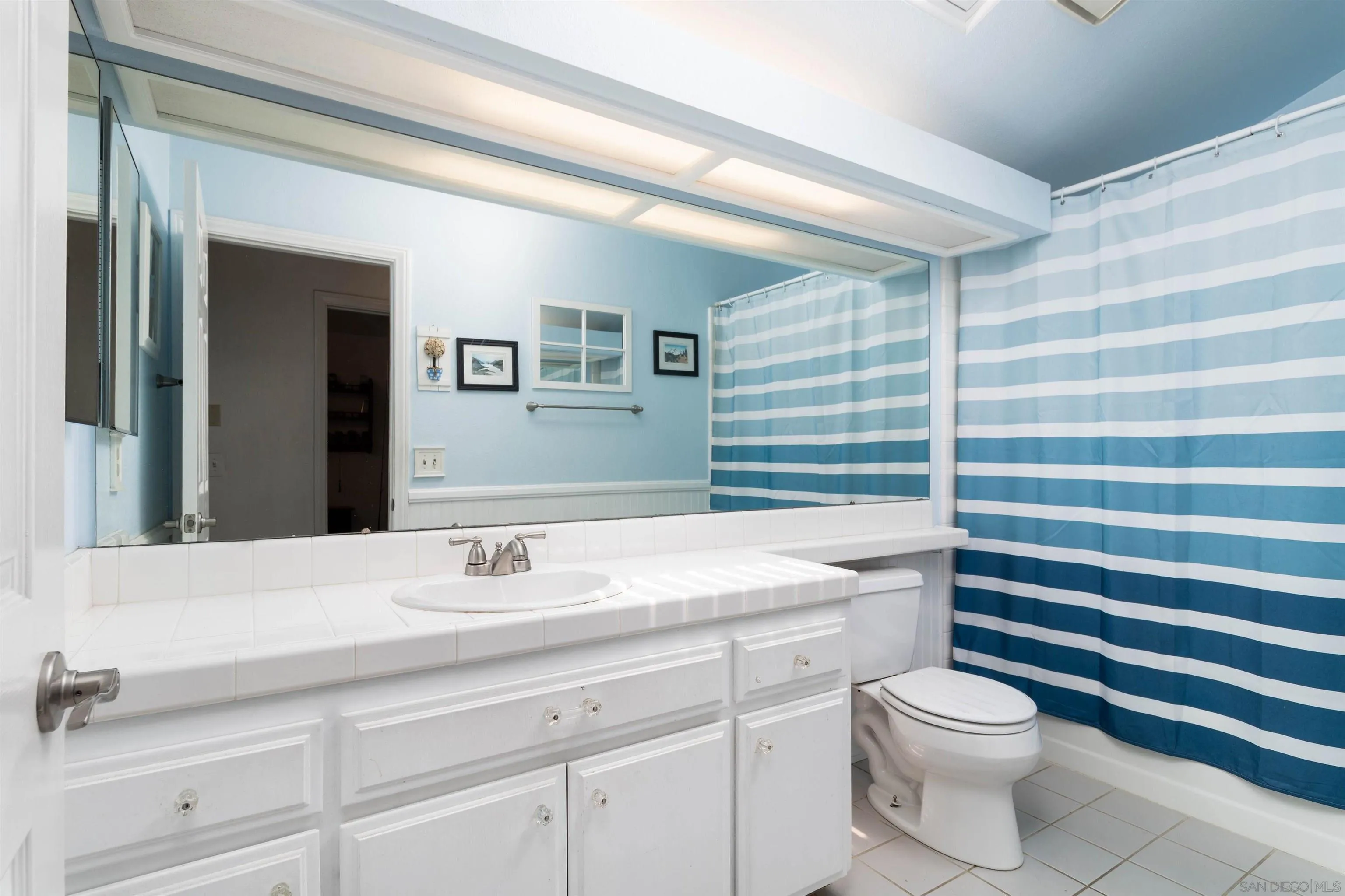 27373 Carlata Lane Valley Center, CA 92082 - Photo 19 of 22 a bathroom with a sink a toilet and a mirror