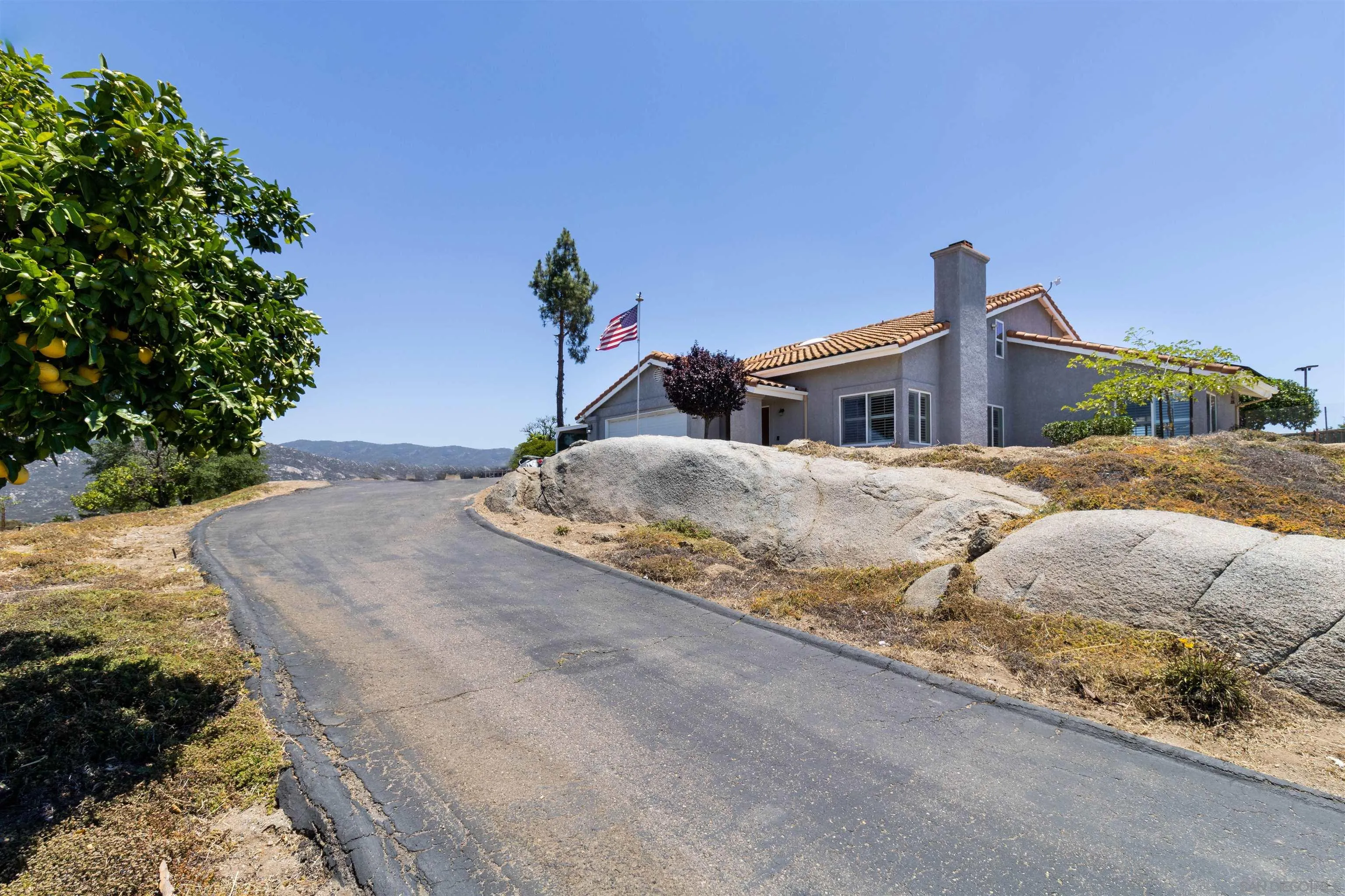 27373 Carlata Lane Valley Center, CA 92082 - Photo 3 of 22 a front view of a house with a yard