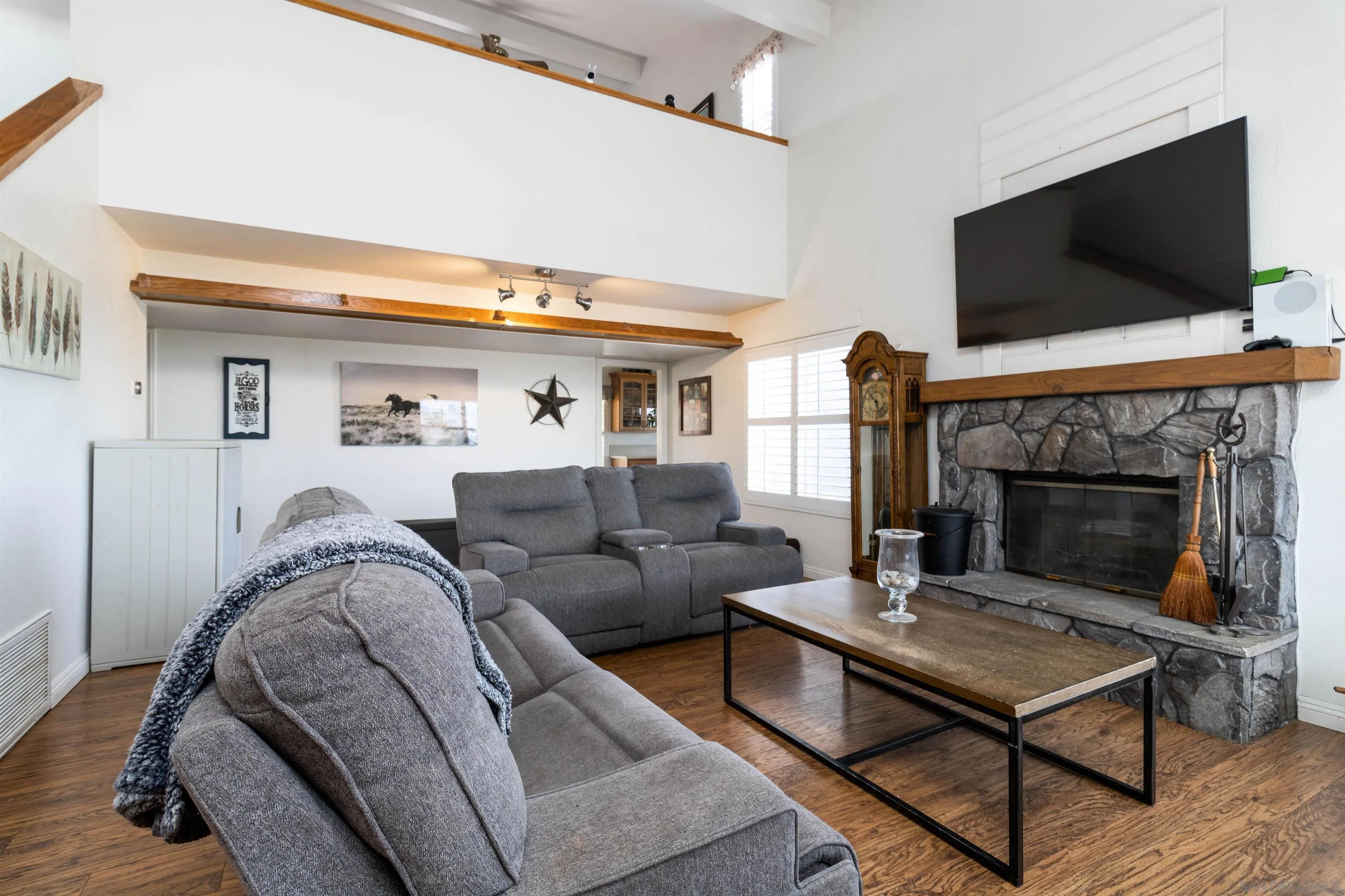 27373 Carlata Lane Valley Center, CA 92082 - Photo 6 of 22 a living room with furniture flat screen tv and a fireplace