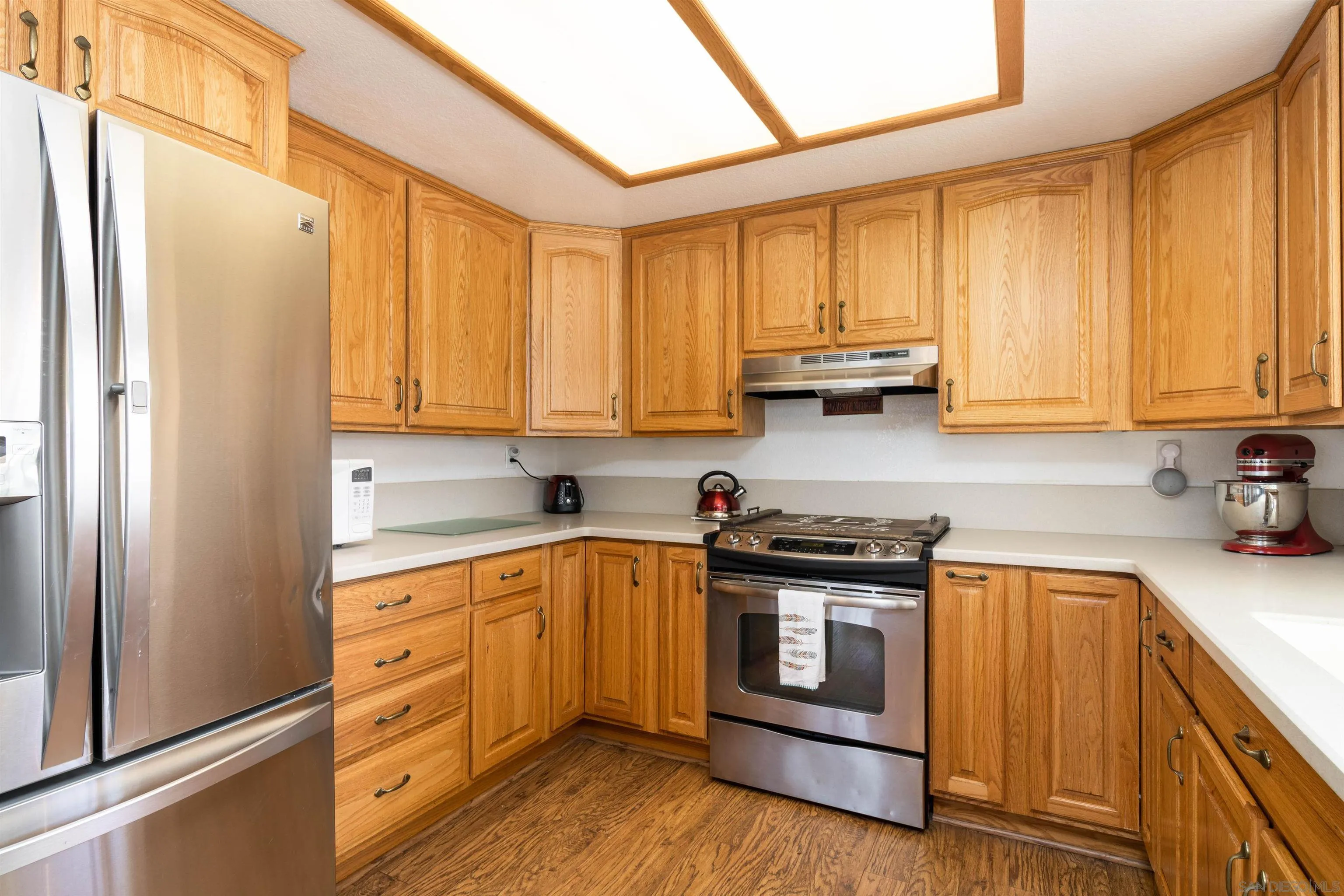 27373 Carlata Lane Valley Center, CA 92082 - Photo 9 of 22 a kitchen with stainless steel appliances granite countertop a stove a sink and a refrigerator with cabinets