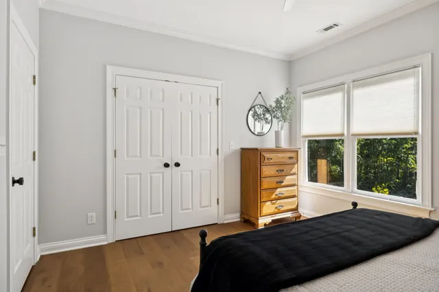 an aerial view of residential houses with outdoor space and trees