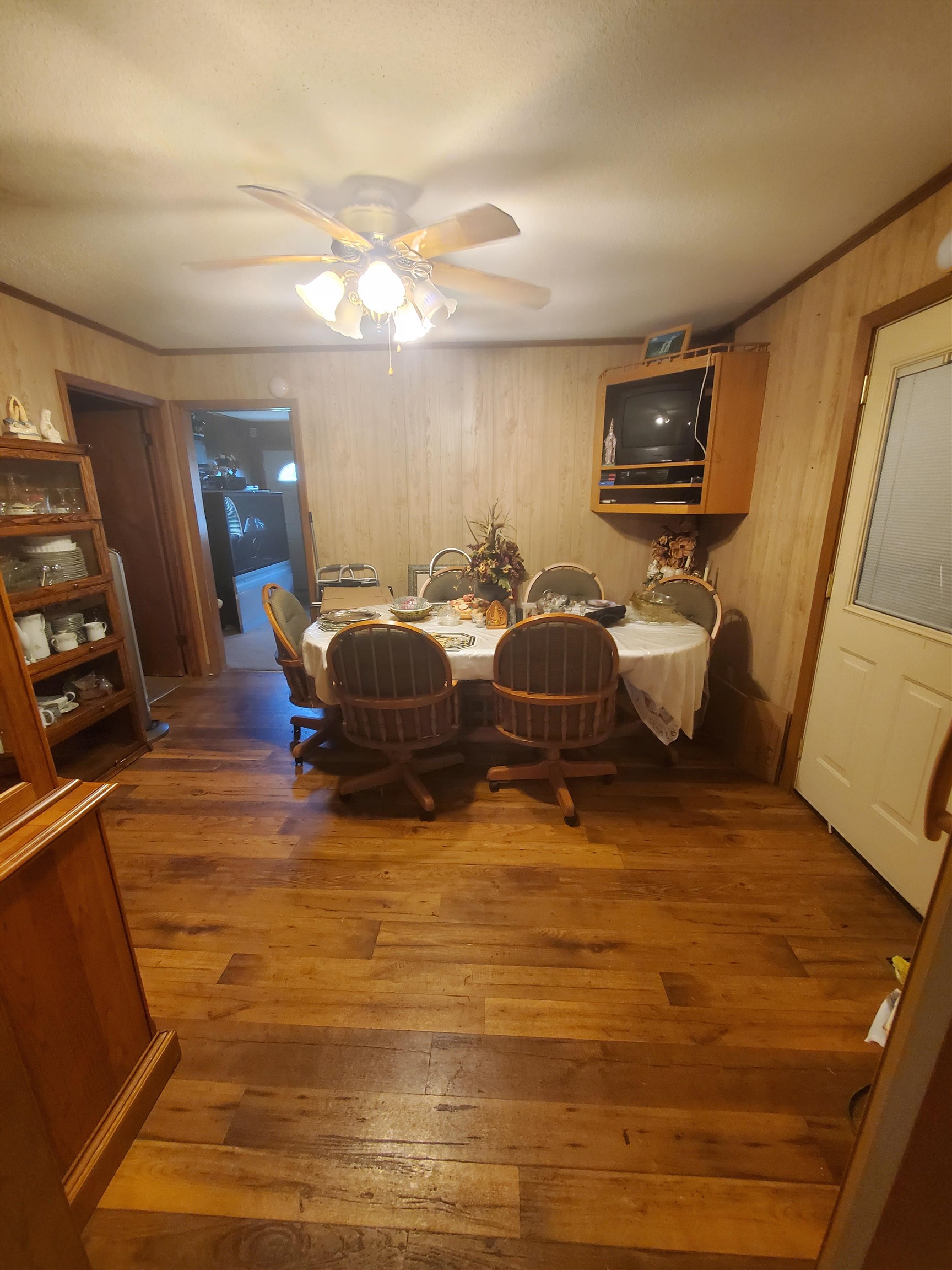 147 Rogers Street Sharon, TN 38255 - Photo 11 of 16 Wood-finish flooring throughout, complemented by wood-paneled walls