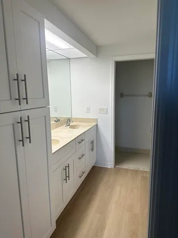 a bathroom with a double vanity sink and mirror
