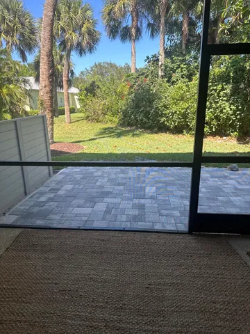 a view of a yard with a table and plants