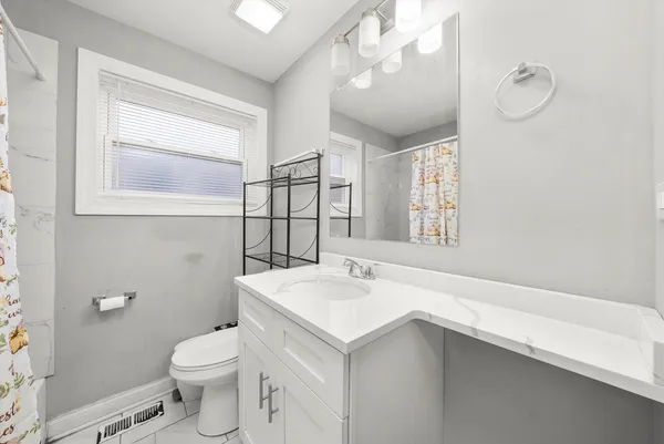a bathroom with a sink a toilet and mirror