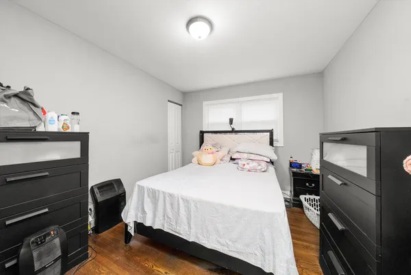 a bedroom with a bed and a tv on the dresser