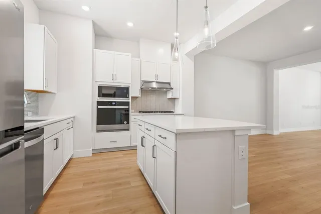 a kitchen with a refrigerator and a sink