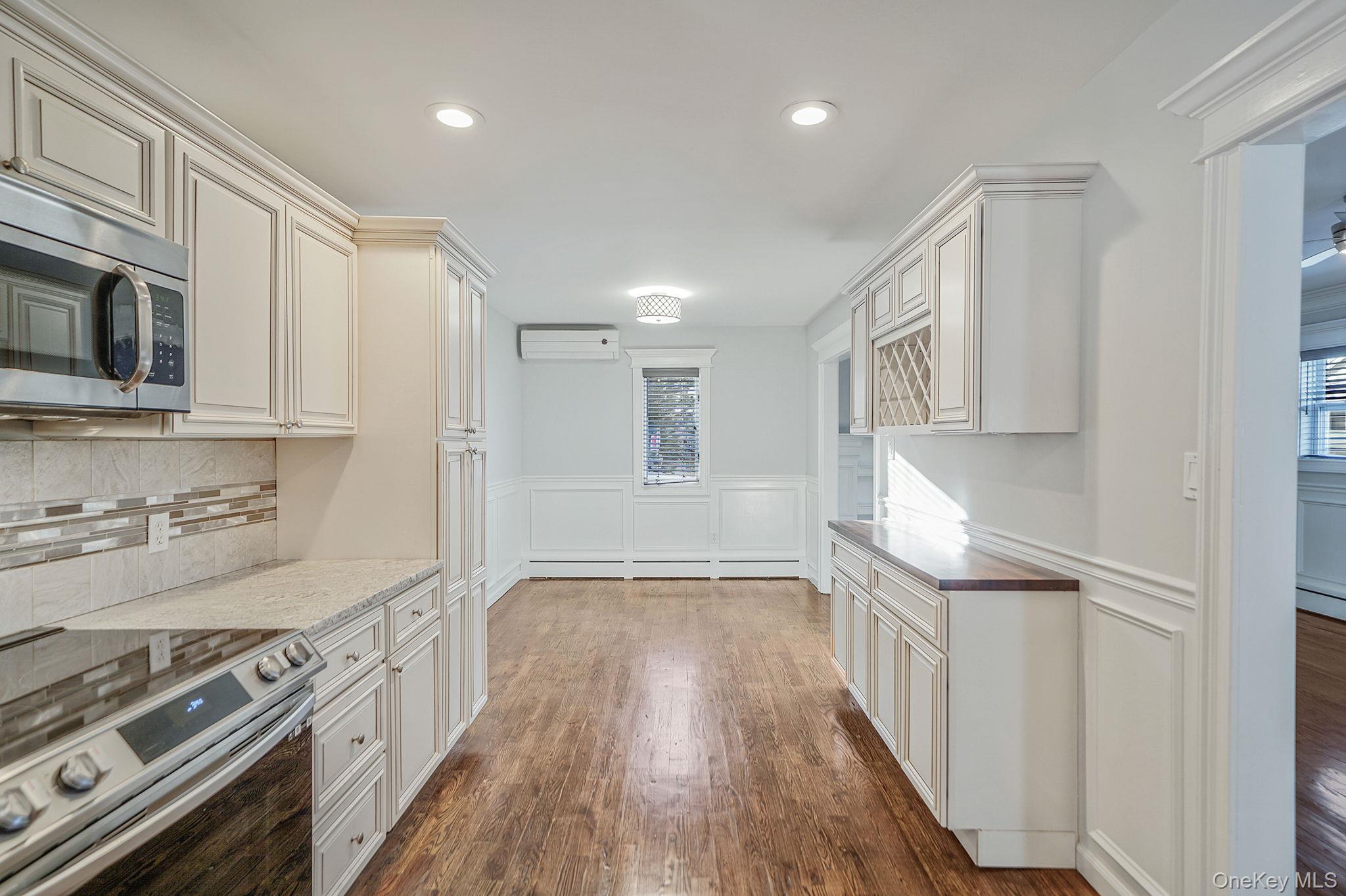 38 Hawthorne Road Rocky Point, NY 11778 - Photo 11 of 27 a kitchen with granite countertop a stove top oven and cabinets