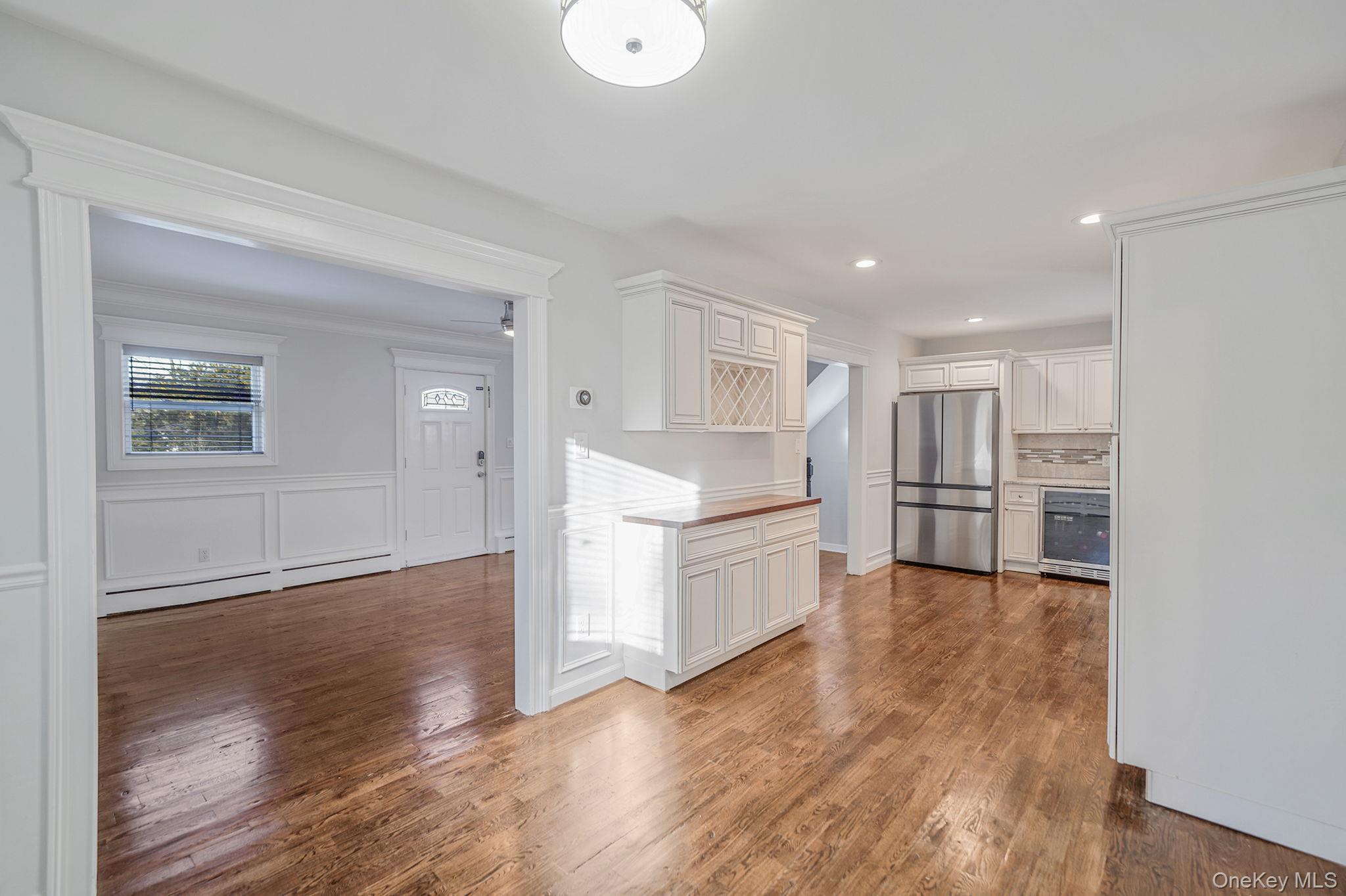 38 Hawthorne Road Rocky Point, NY 11778 - Photo 12 of 27 a kitchen with white cabinets and stainless steel appliances
