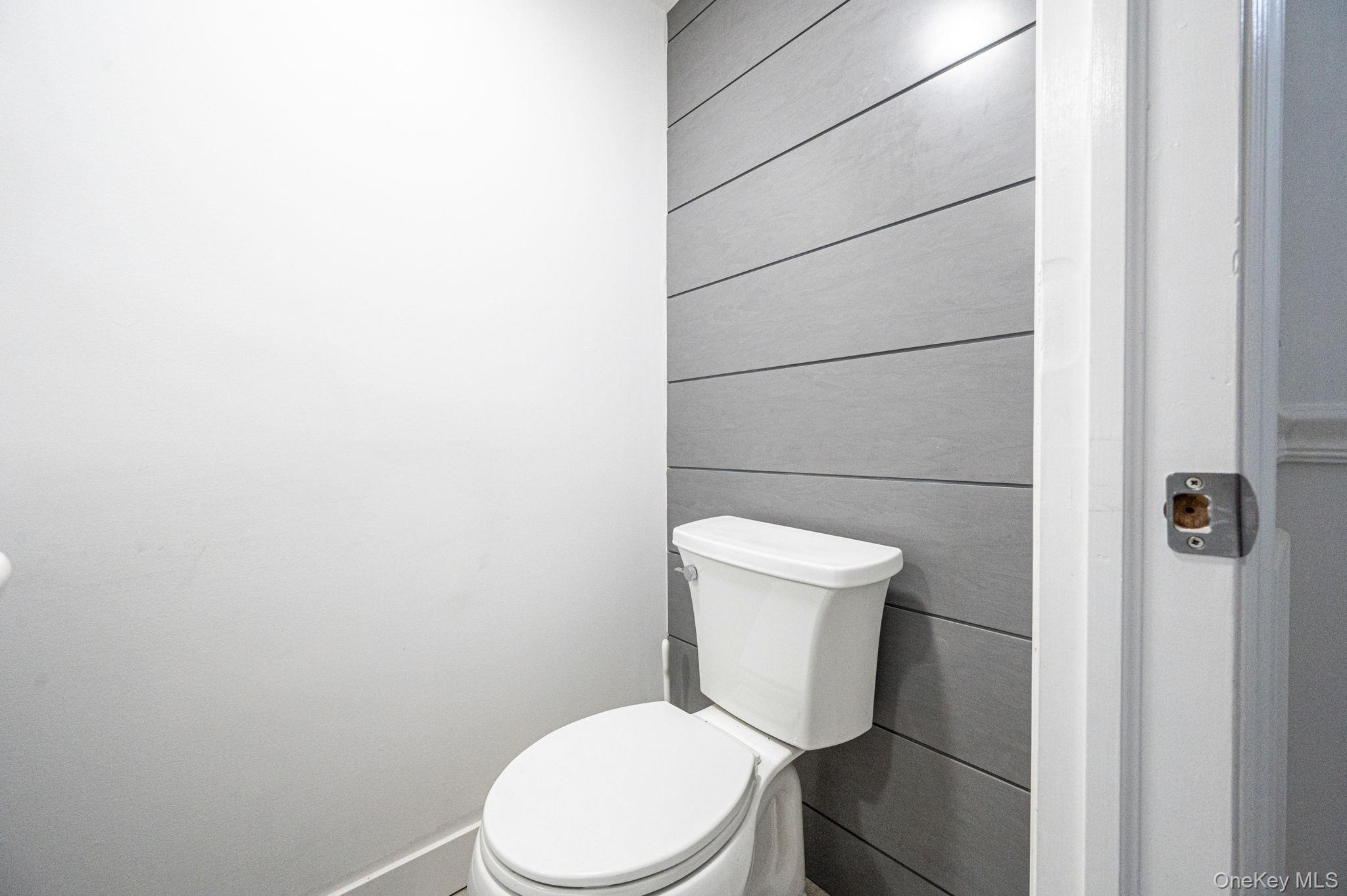 38 Hawthorne Road Rocky Point, NY 11778 - Photo 15 of 27 a white toilet sitting next to a white wall