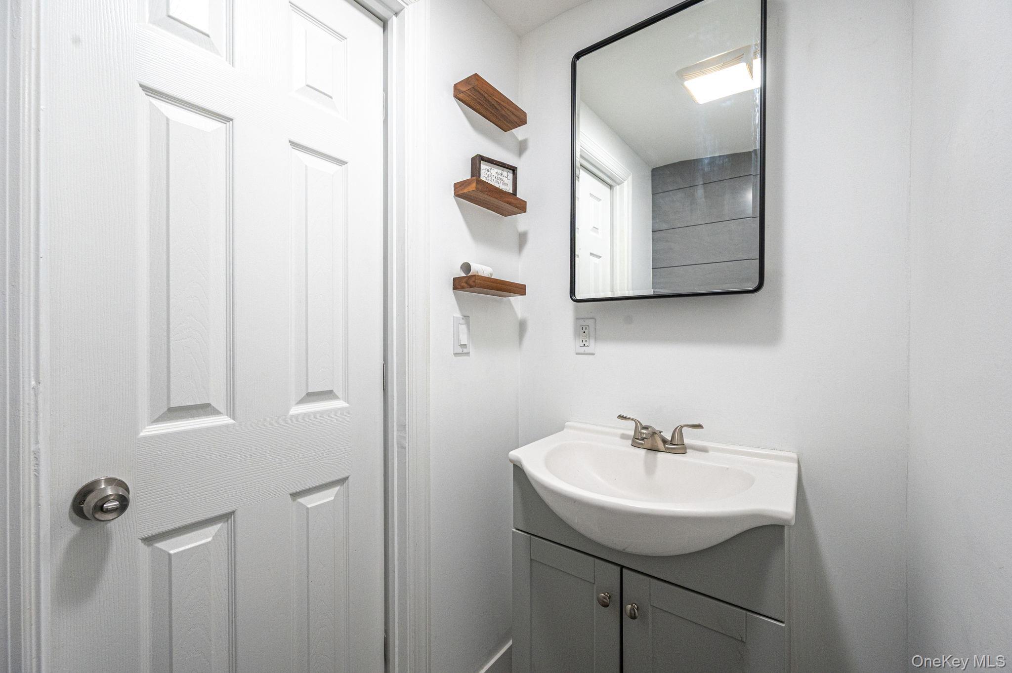 38 Hawthorne Road Rocky Point, NY 11778 - Photo 16 of 27 a bathroom with a sink and mirror