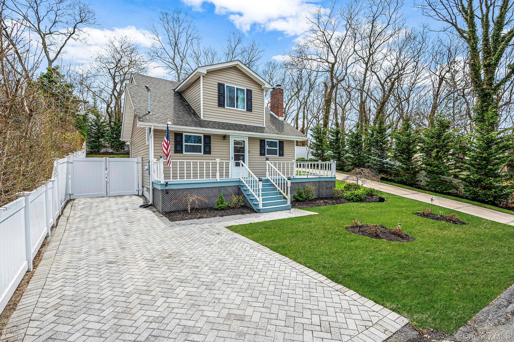 38 Hawthorne Road Rocky Point, NY 11778 - Photo 2 of 27 a front view of a house with a yard and trees
