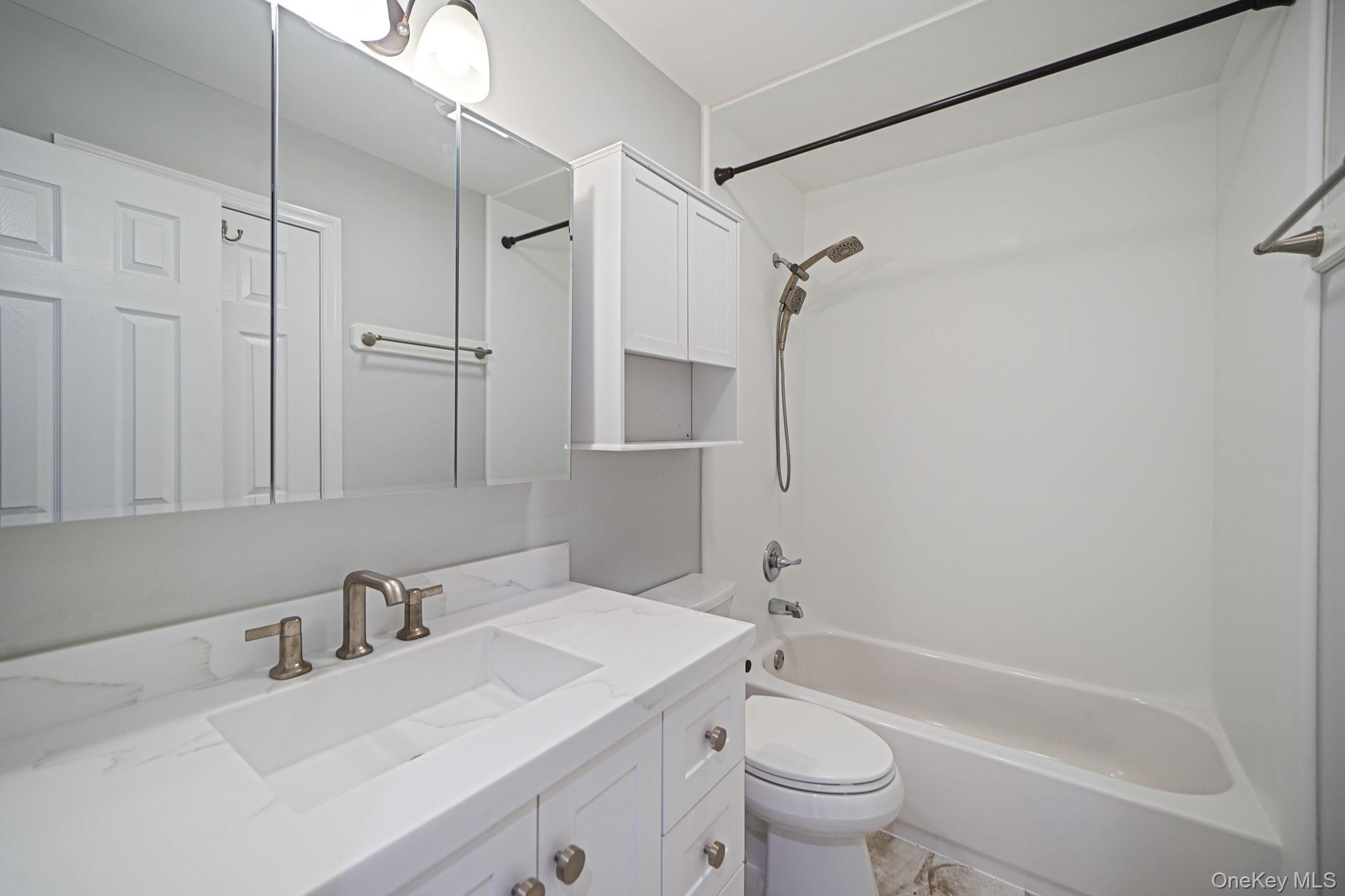 38 Hawthorne Road Rocky Point, NY 11778 - Photo 21 of 27 a bathroom with a sink toilet vanity and shower