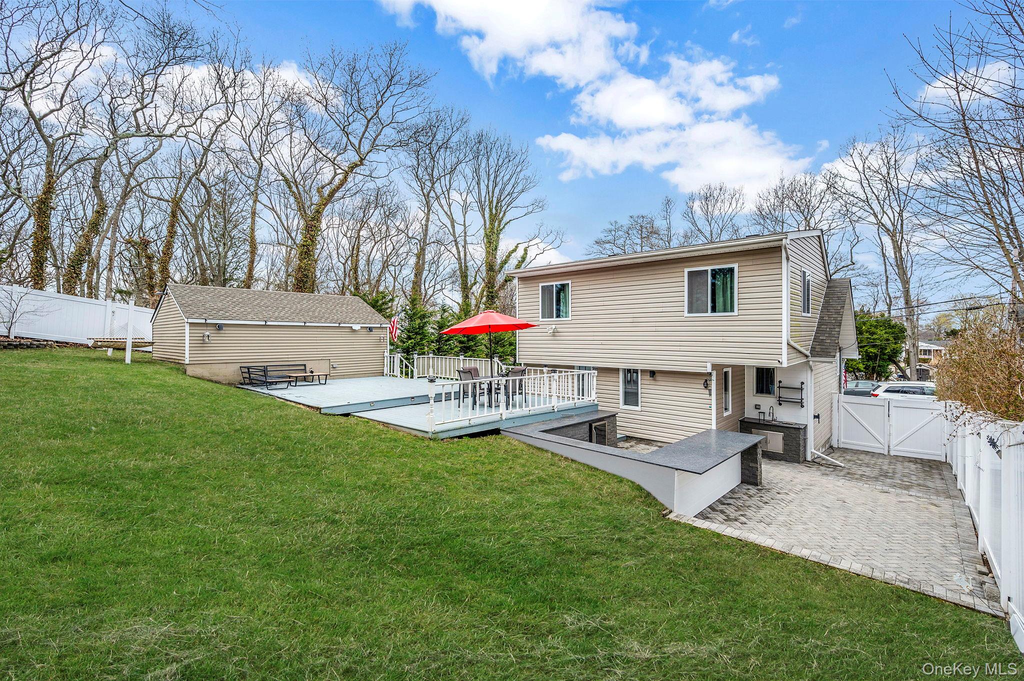 38 Hawthorne Road Rocky Point, NY 11778 - Photo 4 of 27 a view of a house with backyard and sitting area