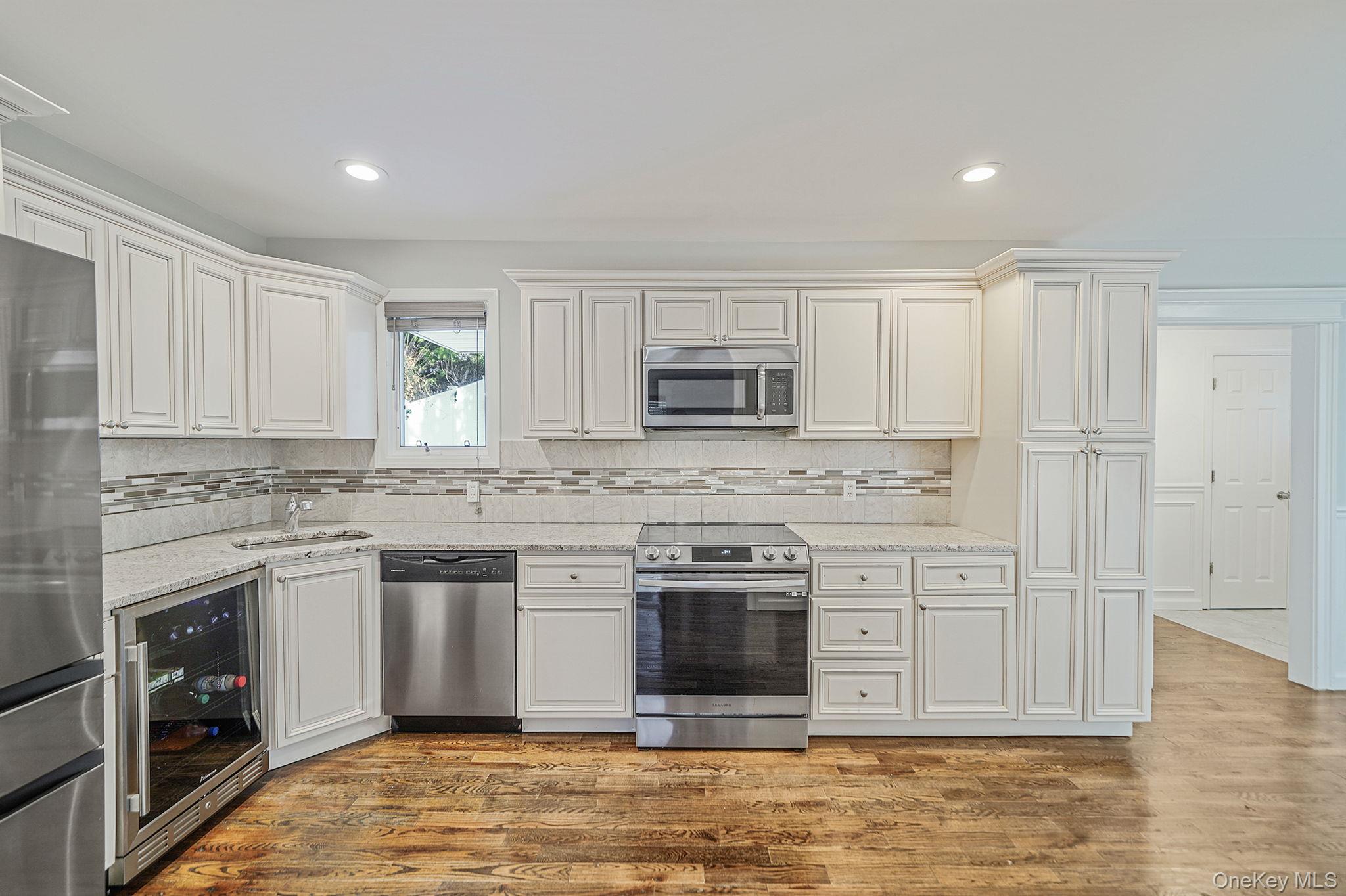 38 Hawthorne Road Rocky Point, NY 11778 - Photo 10 of 27 a kitchen with stainless steel appliances granite countertop a stove a sink and a microwave
