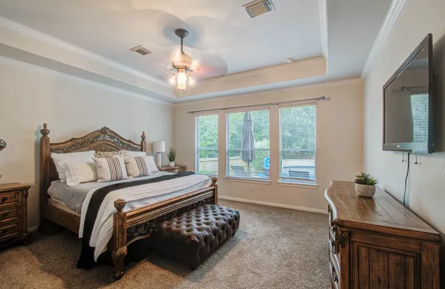 a bedroom with a bed and a chandelier