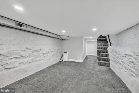 a view of an empty room with stairs